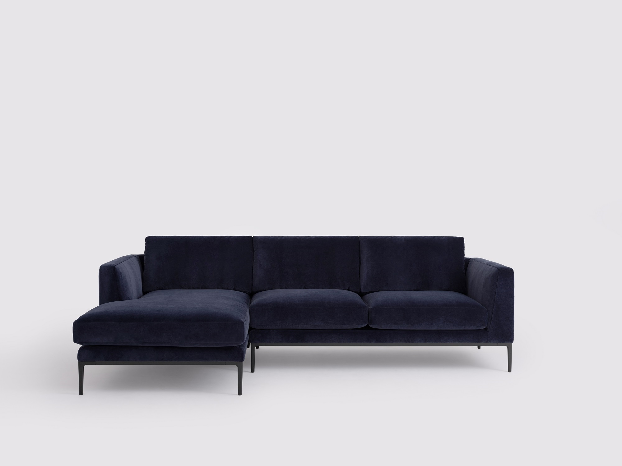 Front view of the Oma modern sectional couch in blue velvet with left hand chaise